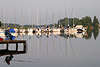 56574_ Angler, Mann im Klappastuhl am Wasser im Angelurlaub sitzen, auf Fisch warten am ruhigem See Steg