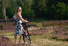 Mädchen Porträt mit Rad locker Kleid Sonnenhut Naturfoto auf Wanderweg blühender Heide