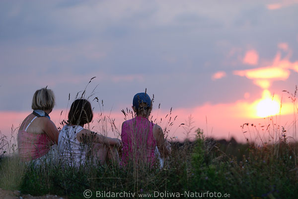 Women-trio by sunset in grasses
