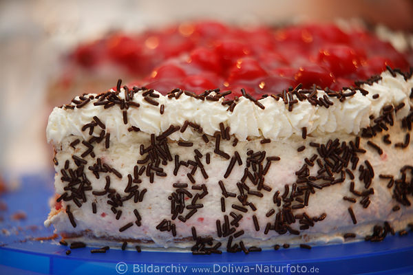 Kirschsahnetorte Tortenrand in Sahne bestreut mit Streuselschokolade oben Kaiserkischen