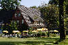 58934_Witthöft’s Gästehaus in Wilsede: Garten der Gaststätte mit Touristen an Tischen Ferienzeit unter Sonnenschirmen