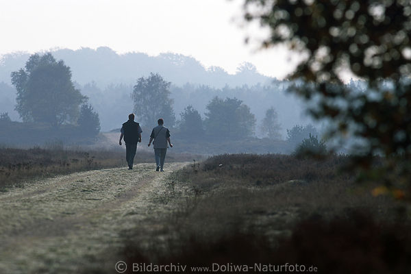 Heidepfad Wander-Duo in Ferne Feldweg schemenhafte Waldkonturen