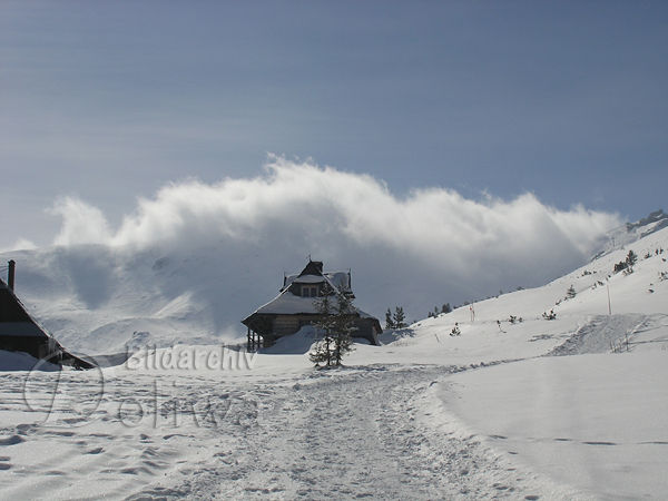 Sennhtte in Schneelandschaft am Skipfad Wanderpfad unter Wolke ber Berg bei Wetterumschwung
