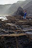 9118_ Arrojadouro schwarze Felsenküste Landschaft Foto mit Frau an Felsen