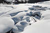 901654_Schneekoppen Schneewehen über Morteratscher Bergbach Naturfoto weißer Winterlandschaft mit Touristin auf Fußweg entlang Baches