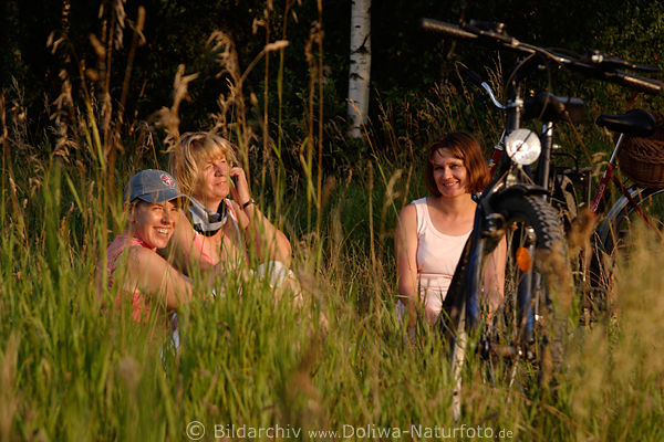 Radlerinnen Rast in Grser Frauen am Wald Trio Naturportrt lachend bei Picknick auf Wiese
