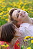 Mädels Zweier auf Blumenwiese lächeln in Gelbblütenfeld lustiges Frauenpaar