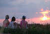 Women-trio by sunset in grasses