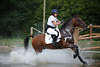 Camilla Dumas Reiterin Cross country Aktionporträt im Wassergraben Foto auf Englands Pferd Action Packed