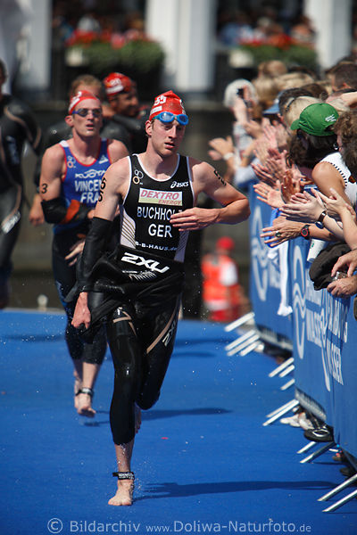 Triathlet Gregor Buchholz Lauf im Schwimmanzug auf blauen WM-Teppich