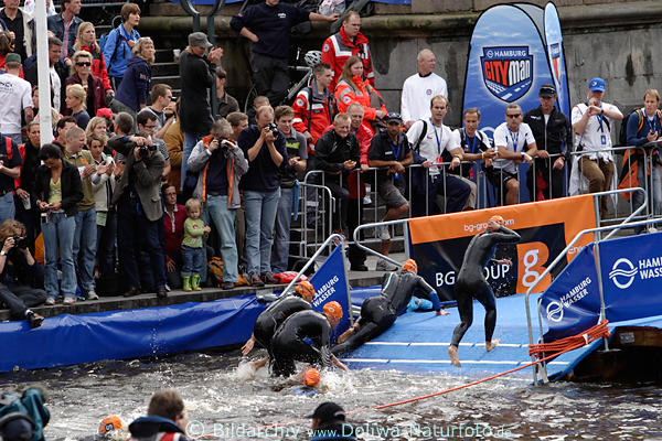 Triathlon-Schwimmerin ausgerutscht beim Herauslaufen aus Wasser auf nasse Laufbahn liegend